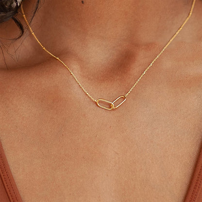 Woman wearing a dainty gold stainless steel infinity link necklace with minimalist modern style.