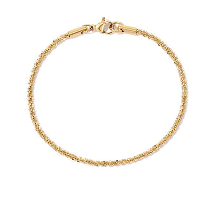 Adjustable gold stainless steel gypsophila bracelet with glitter-like textured design, isolated shot.
