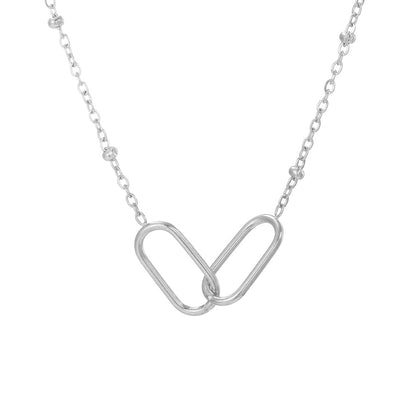 Silver infinity link stainless steel pendant necklace with minimalist chain isolated on white background.